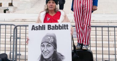 FILE - Micki Witthoeft, center, mother of Ashli Babbitt, the woman fatally shot by police inside the U.S. Capitol during the Jan. 6, 2021, riot, joins protesters outside of the Supreme Court on the second anniversary of the Jan. 6, assault on the U.S. Capitol, in Washington,, Jan. 6, 2023. (AP Photo/Jose Luis Magana)