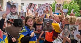 Relatives show photos of missing soldiers