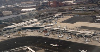 Aerial view of airplanes parked at gates in an airport terminal.