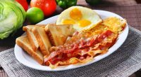 Plate of bacon, eggs, hash browns, and toast.