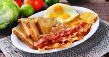 Plate of bacon, eggs, hash browns, and toast.