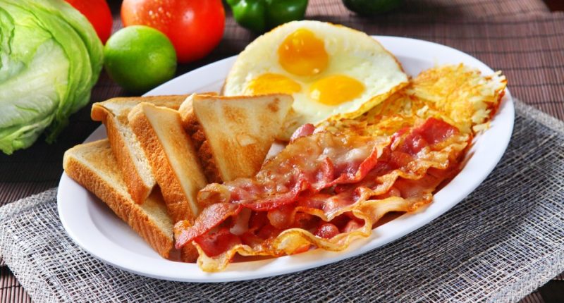 Plate of bacon, eggs, hash browns, and toast.
