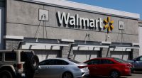 Walmart store exterior with cars parked in front.