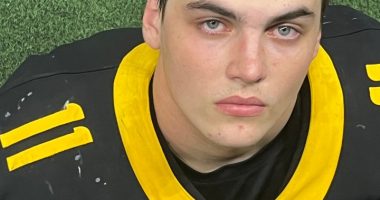 Photo of Austin Metcalf in a football jersey.