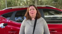 Woman giving an interview, visibly upset.