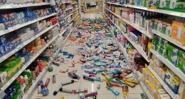 Store aisle with products scattered on the floor after an earthquake.