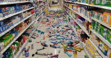 Store aisle with products scattered on the floor after an earthquake.