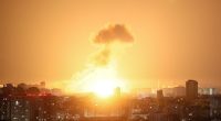 Ballistic missile explosion over a city at night.