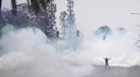 After tear gas and street fires, a Los Angeles community cleans up as National Guard troops arrive