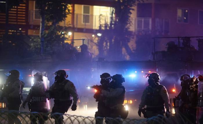 After tear gas and street fires, an Los Angeles community cleans up as National Guard troops arrive