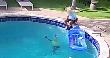 A six-year-old boy drowning in a pool while an adult watches helplessly until a stranger intervenes.