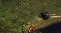 Aerial view of kayakers and a damaged kayak after an alligator attack.