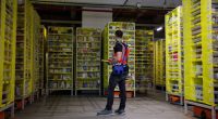 A maintenance employee works in a robotic warehouse at Amazon's centre of Bretigny-sur-Orge in December 2021.