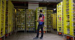 A maintenance employee works in a robotic warehouse at Amazon's centre of Bretigny-sur-Orge in December 2021.