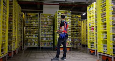 A maintenance employee works in a robotic warehouse at Amazon's centre of Bretigny-sur-Orge in December 2021.
