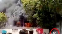 Footage of a man calmly walking away from a large fire.
