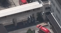 Aerial view of emergency vehicles outside a Japanese high school.