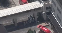 Aerial view of emergency vehicles outside a Japanese high school.