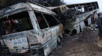 Burned-out buses after a fatal collision.