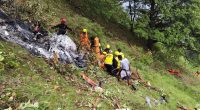 Rescue workers at a helicopter crash site.