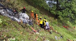 Rescue workers at a helicopter crash site.