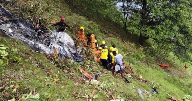 Rescue workers at a helicopter crash site.