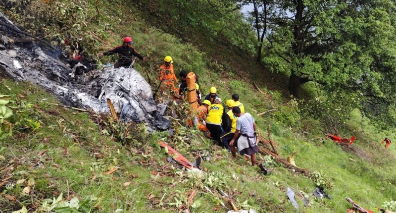 Rescue workers at a helicopter crash site.