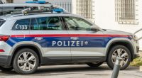 Police car parked at a white building. Police car at police station. side view of the car. Polizei in German. 22 july 2024, Imst, Austria