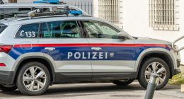 Police car parked at a white building. Police car at police station. side view of the car. Polizei in German. 22 july 2024, Imst, Austria