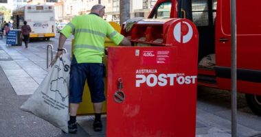 Adelaide, Australia - 18 Feb 2021: A Australia Post postmen is collecting the post from the mail box.