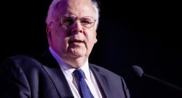 Frederick Smith, FedEx CEO, speaking at a podium.