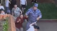 A soldier points a gun at a woman's head during a restaurant brawl.