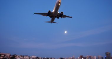 Boeing 737 approaching San Diego International Airport at sunset.