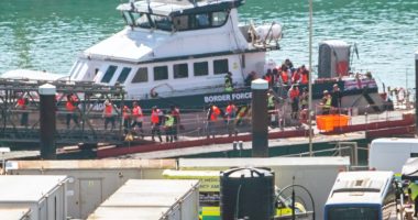 Migrants disembarking a Border Force vessel at Dover Docks.