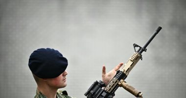 Royal Netherlands Marine Corps member inspecting a weapon.