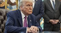 President Donald Trump sitting at a table in the Oval Office.