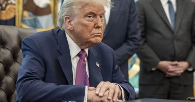 President Donald Trump sitting at a table in the Oval Office.