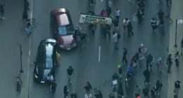 Car drives through anti-ICE protesters as Chicago joins nationwide anti-ICE unrest amid Trump crackdown