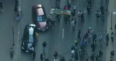 Car drives through anti-ICE protesters as Chicago joins nationwide anti-ICE unrest amid Trump crackdown