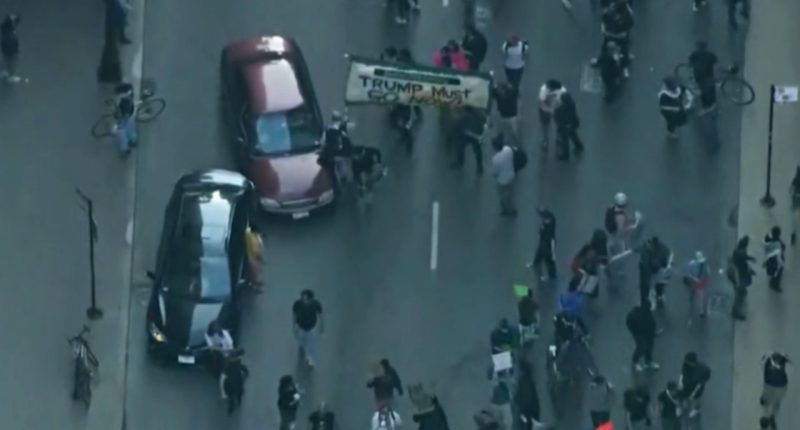Car drives through anti-ICE protesters as Chicago joins nationwide anti-ICE unrest amid Trump crackdown