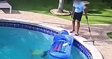 Child starts drowning in pool while adult with him stands beside it
