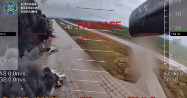 Drone footage of burning planes on a runway.
