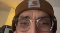 Tanner in a brown beanie and glasses.