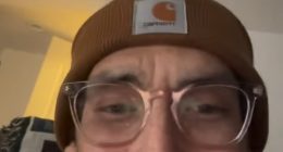 Tanner in a brown beanie and glasses.