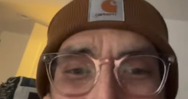 Tanner in a brown beanie and glasses.