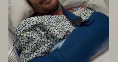 David Beckham in a hospital bed with his arm in a sling.