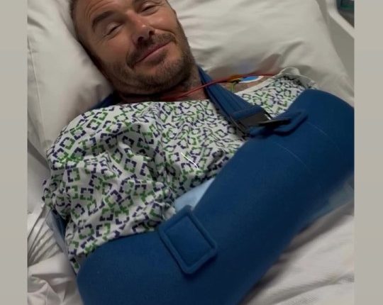 David Beckham in a hospital bed with his arm in a sling.