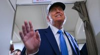 President Trump aboard Air Force One, waving.