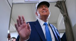 President Trump aboard Air Force One, waving.