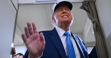 President Trump aboard Air Force One, waving.